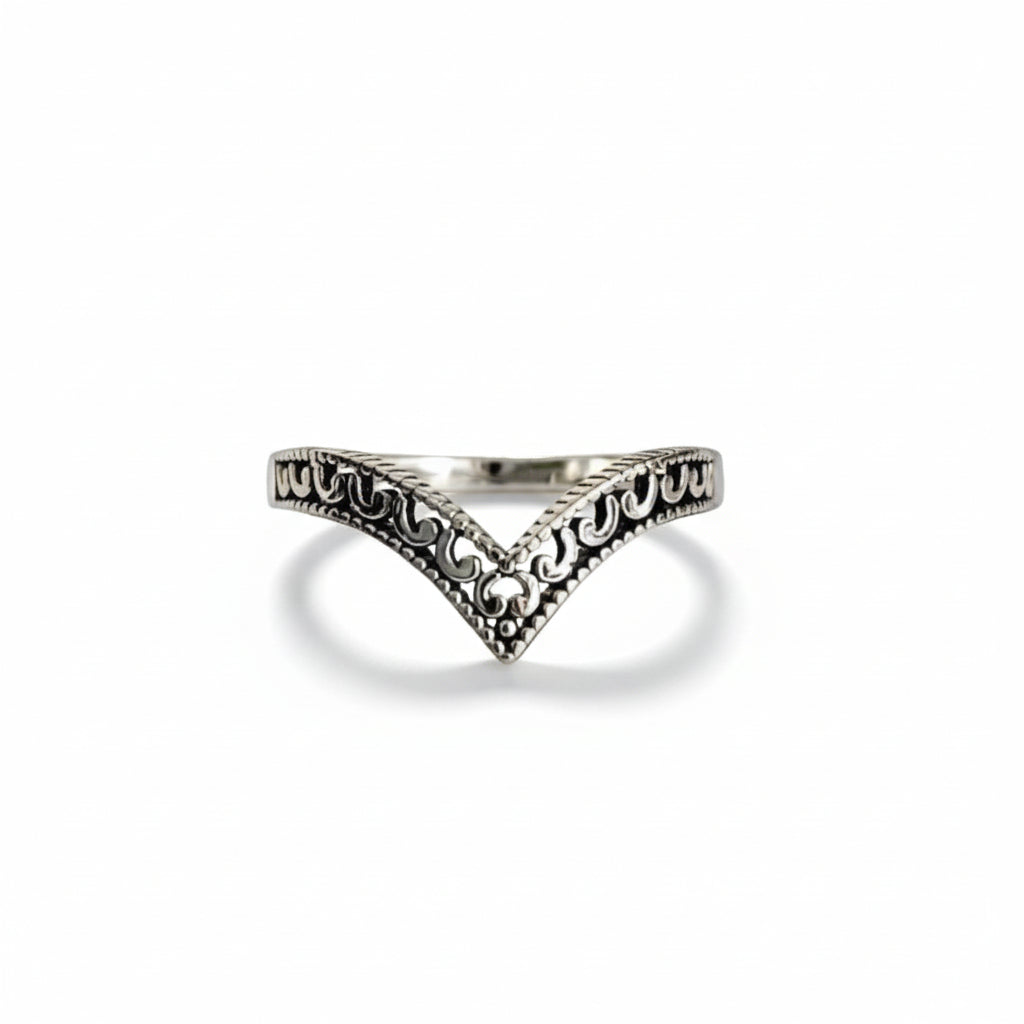 Silver ring with intricate design on a  white background