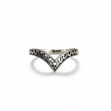 Silver ring with intricate design on a  white background